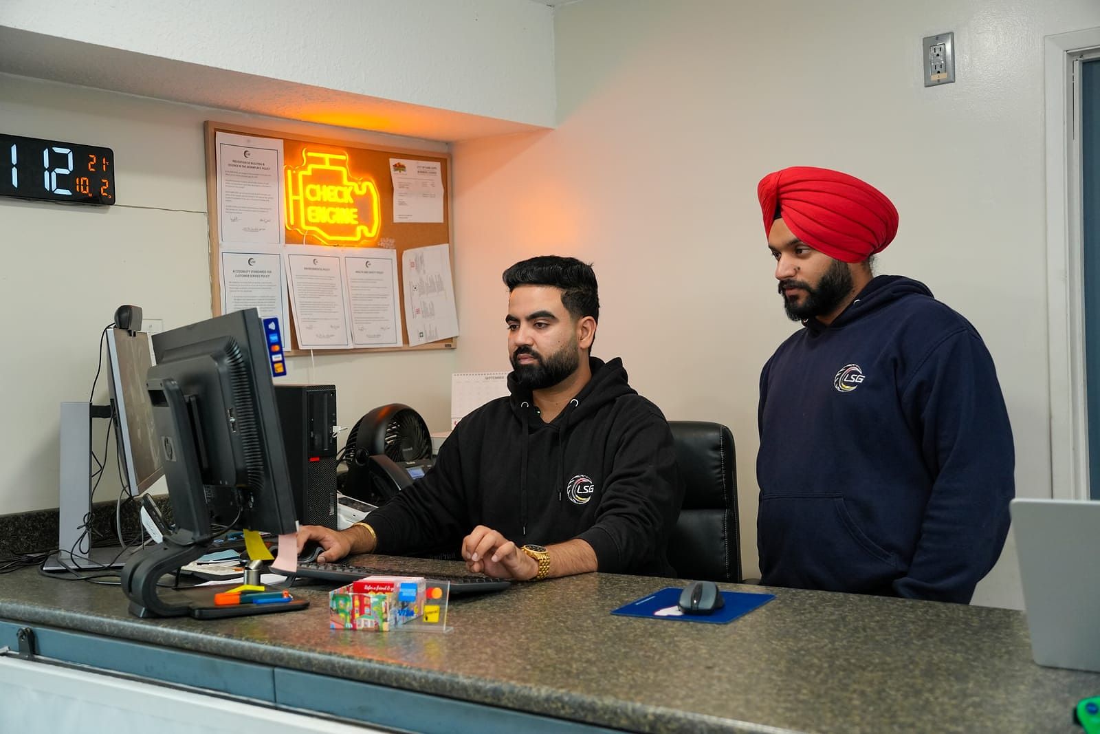 The owners of LSG Auto Nation at the front desk